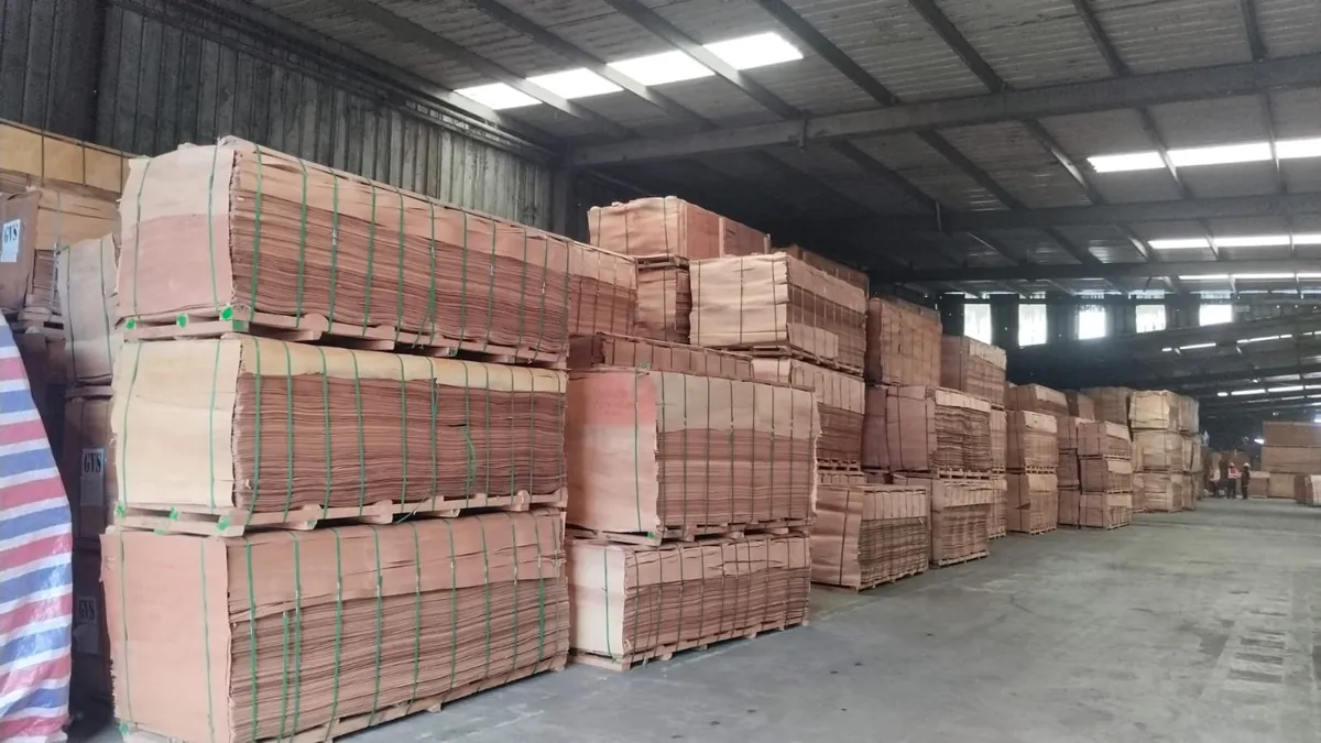 Stacks of smooth, warm-toned okoume face veneer in the warehouse